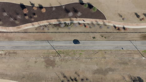 Lonely-car-driving-down-a-single-road.-Aerial