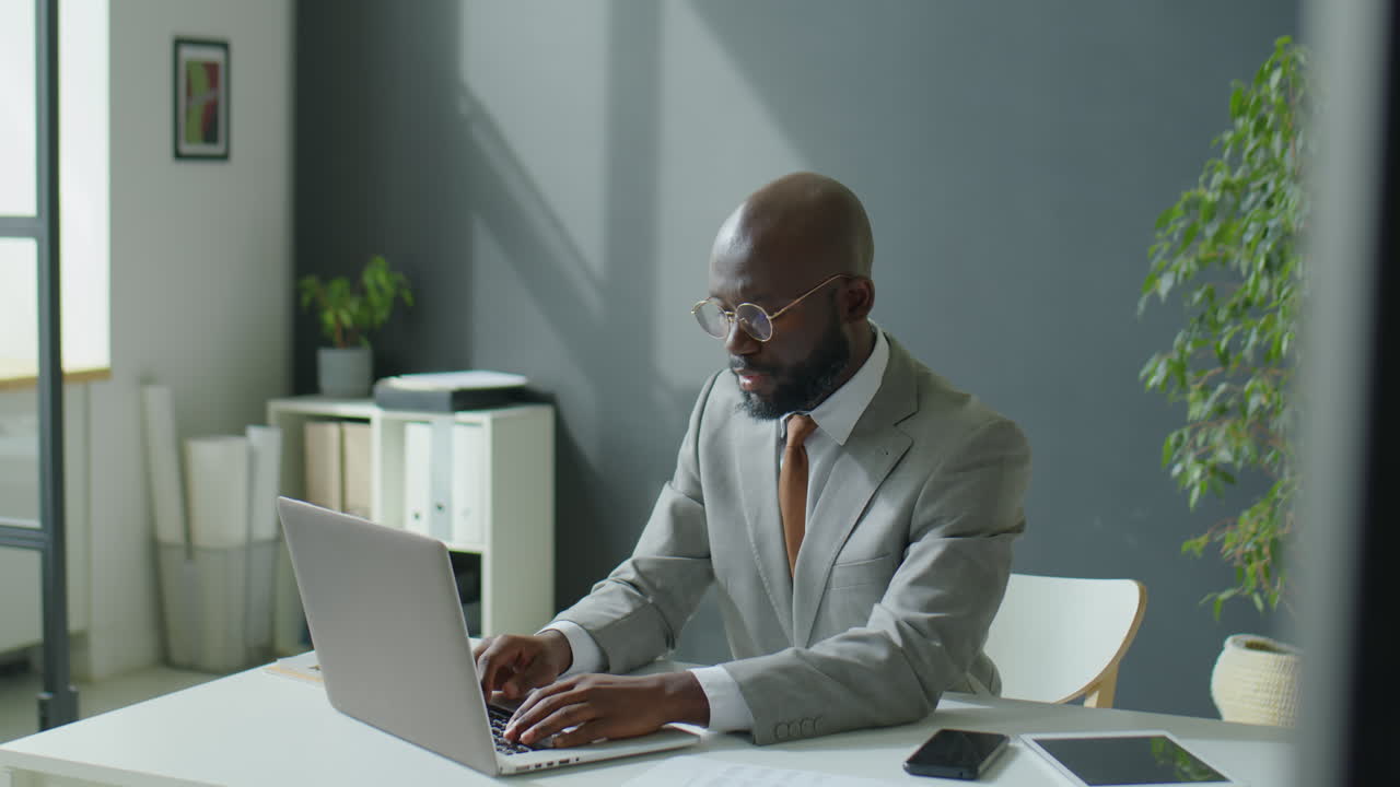 African American Businessman Using Laptop in Office