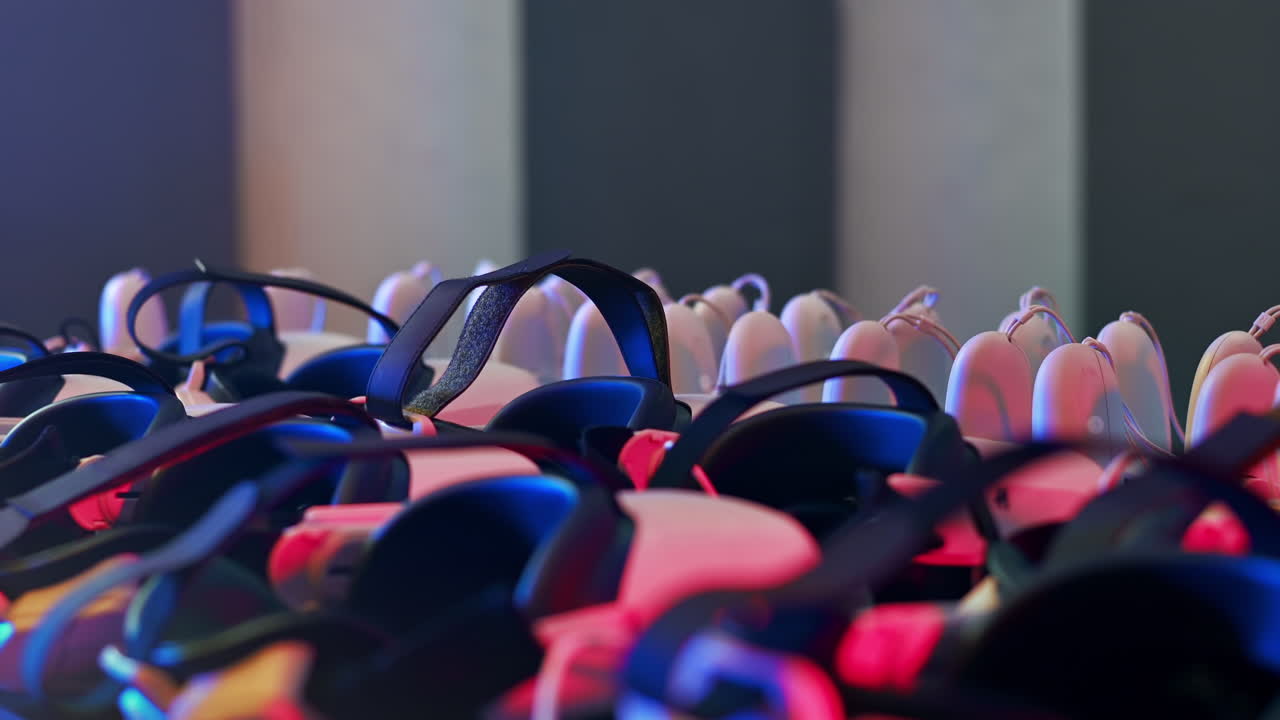Virtual reality VR equipment on a table. Playmates choosing VR headsets and joysticks