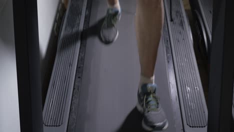 adult male in sneakers walking on a treadmill