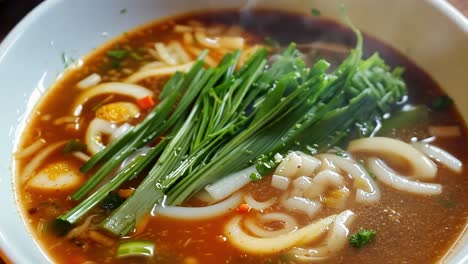 steaming bowl of thai noodle soup