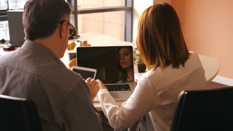 Business-people-using-digital-tablet-and-laptop