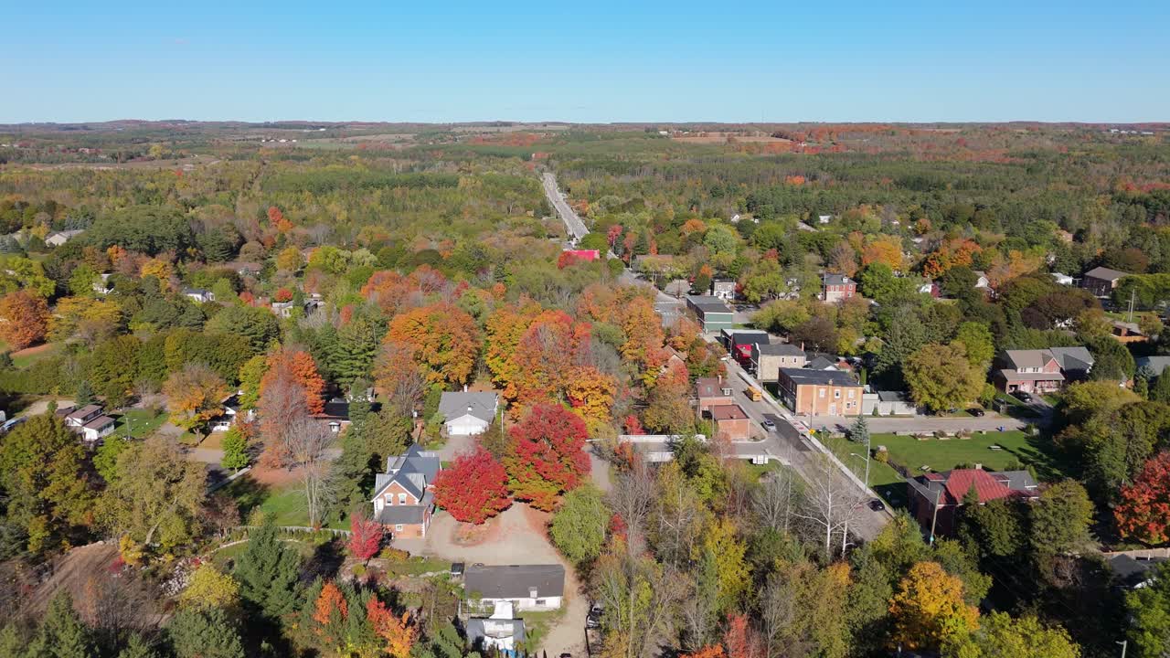 Aerial shot of historic Alton in Caledon, Ontario, showcasing fall colours, tree-lined streets, heritage houses, and the surrounding countryside during peak autumn season