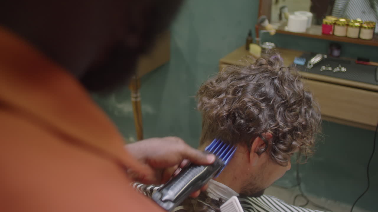 Barber Working with Hair Clippers and Comb