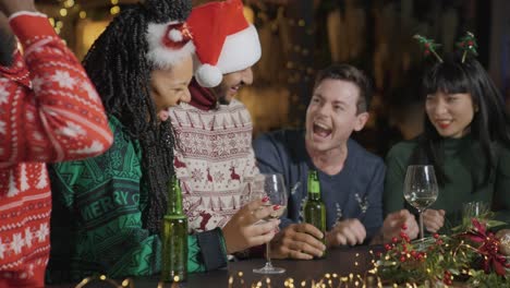 Tracking-Shot-of-a-Drunk-Man-with-His-Friends-During-Christmas-Celebrations-at-Bar