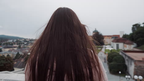 woman taking pictures in a park with a city view