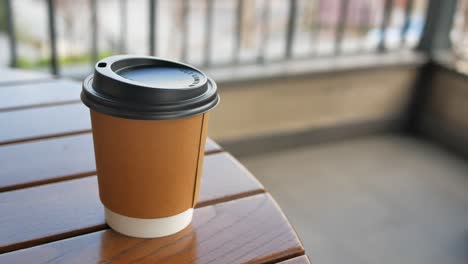 paper coffee cup on wooden table