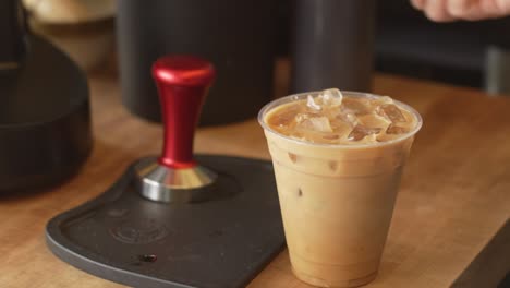 Coffee-shop-barista-stirring-an-iced-coffee