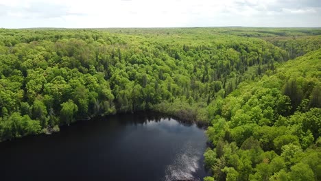 Aerial-Ascent-of-Forested-Lake,-Chapel-Lake,-Pictured-Rocks-National-Lakeshore,-Michigan