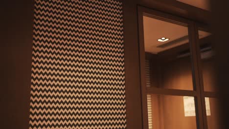 Modern-interior-wall-with-black-and-white-zigzag-pattern-beside-a-glass-door