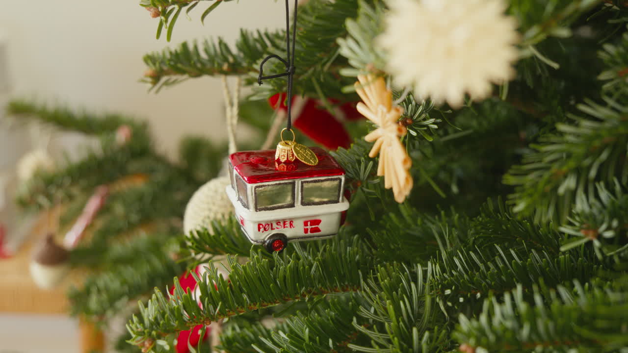 Miniature Danish P&oslash;lsevogn ornament adorning a Christmas tree