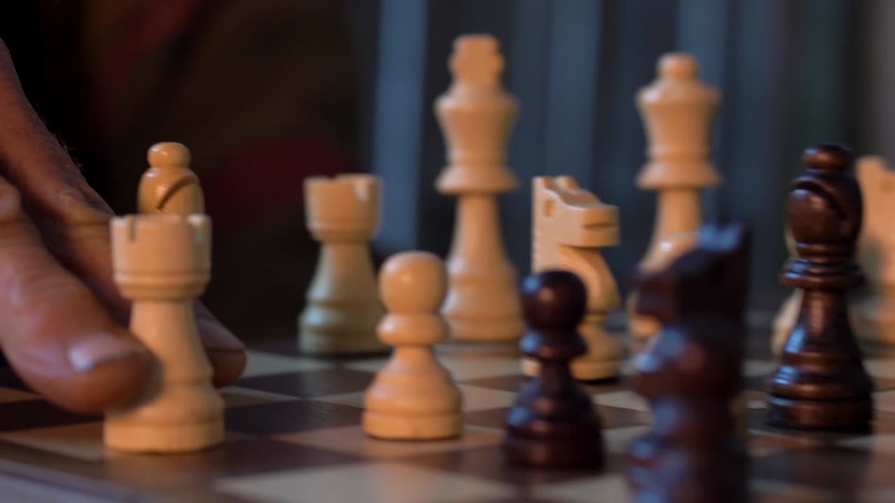 Man Moves White Bishop On Chessboard - close up shot