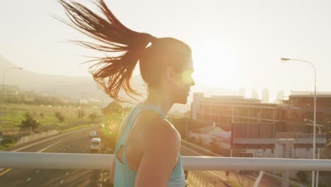 Young-woman-running-on-a-bridge