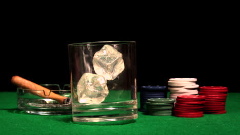 ice cubes falling into glass on casino table