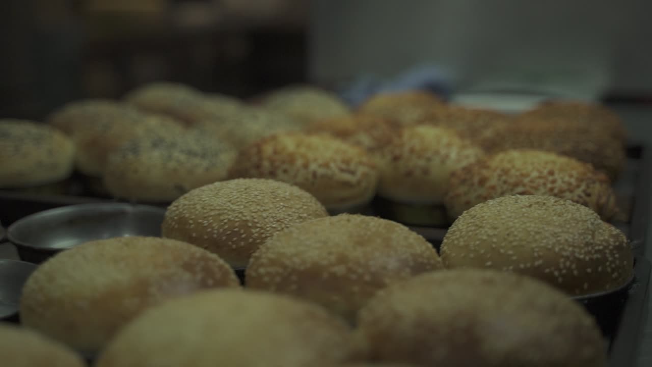 Close up shot of homemade burger bread covered with seeds in cups