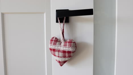 Review-of-a-heart-shaped-door-hanger-hanging-on-a-black-handle