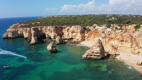 Aerial-shot-of-the-hidden-beaches-along-the-south-coast-of-Algarve,-Portugal