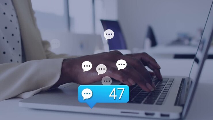 Animation of social media icons over mid section of african american woman using laptop at office