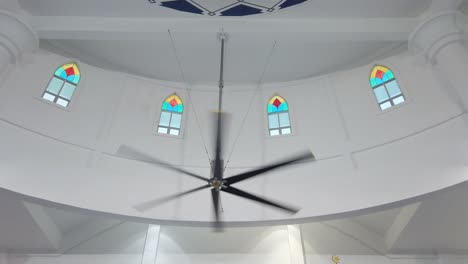 a giant fan is spinning in a building. this type of fan is widely used to cool down the air.