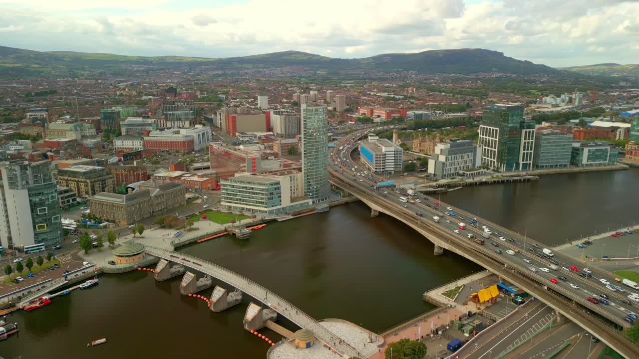 Wide rising 4K aerial video of Belfast City centre and the River Lagan on a sunny afternoon. Produced in 4K, 60FPS and with Rec709 color