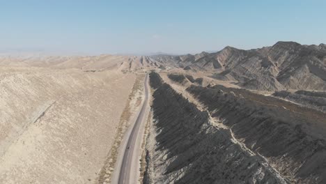 aerial vew over n10 makran coastal highway road beside dramatic rock formations in hingol national park