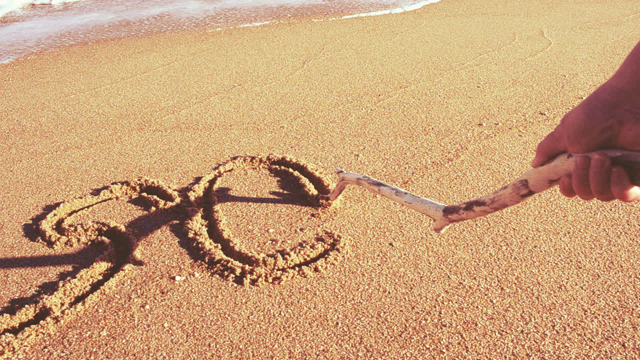 We write words on sand. The word the sos on sand. Shooting on the beach