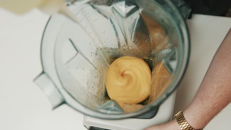 looking into blender as ingredients of japanese mayonnaise are poured into blender