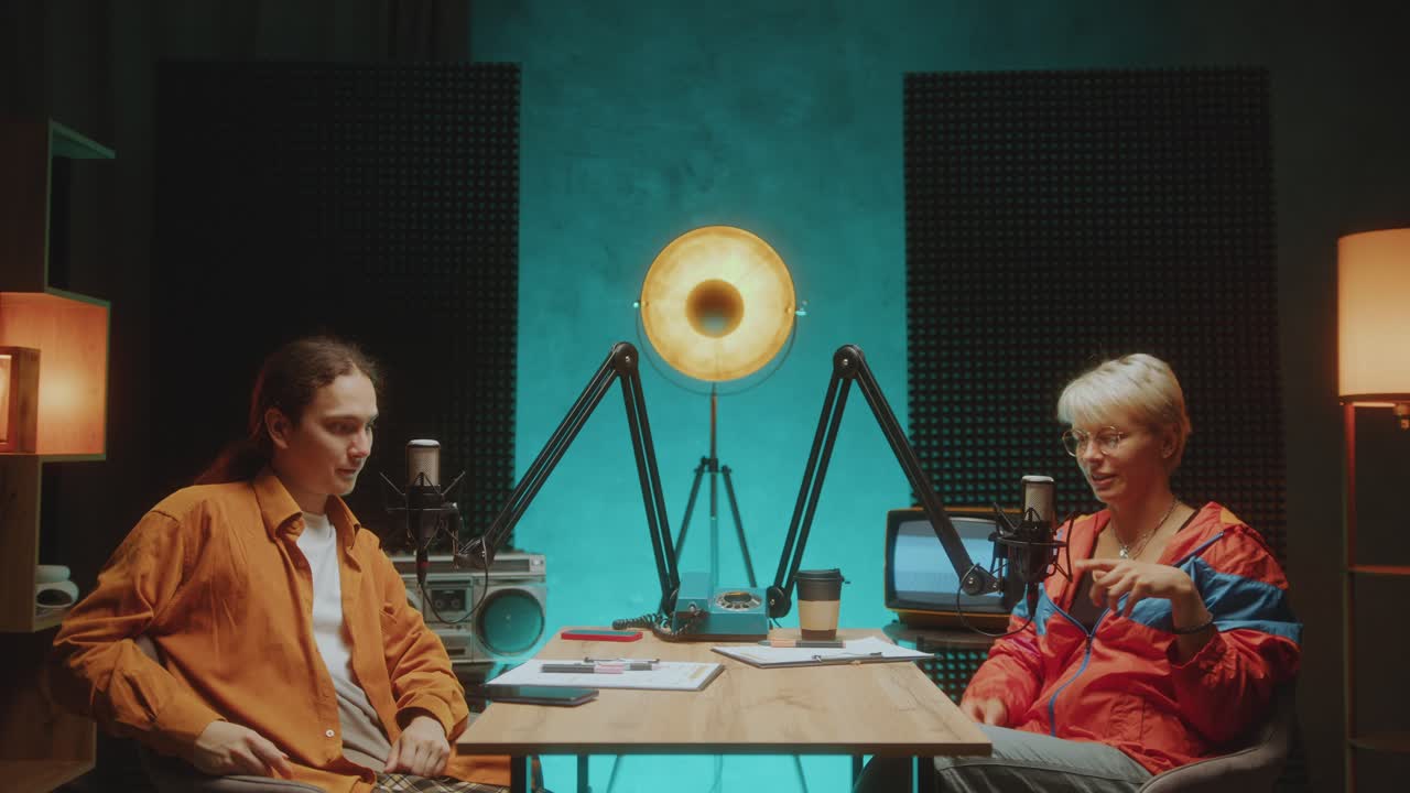 Cheerful Podcast Co-Hosts Introducing Themselves on Camera in Recording Studio