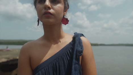 shot of an indian woman wearing a blue back parting with her hair in two pigtails