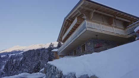 dolly in of beautiful snow covered chalet in the swiss countryside