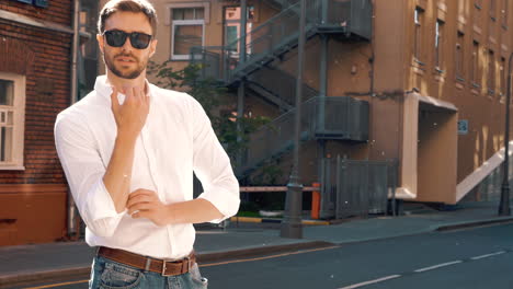 stylish man in a white shirt and sunglasses