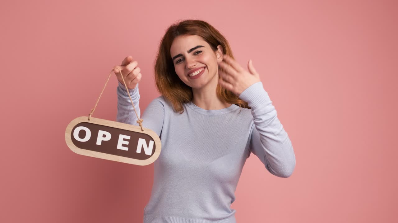 Woman opening a space by putting up a sign
