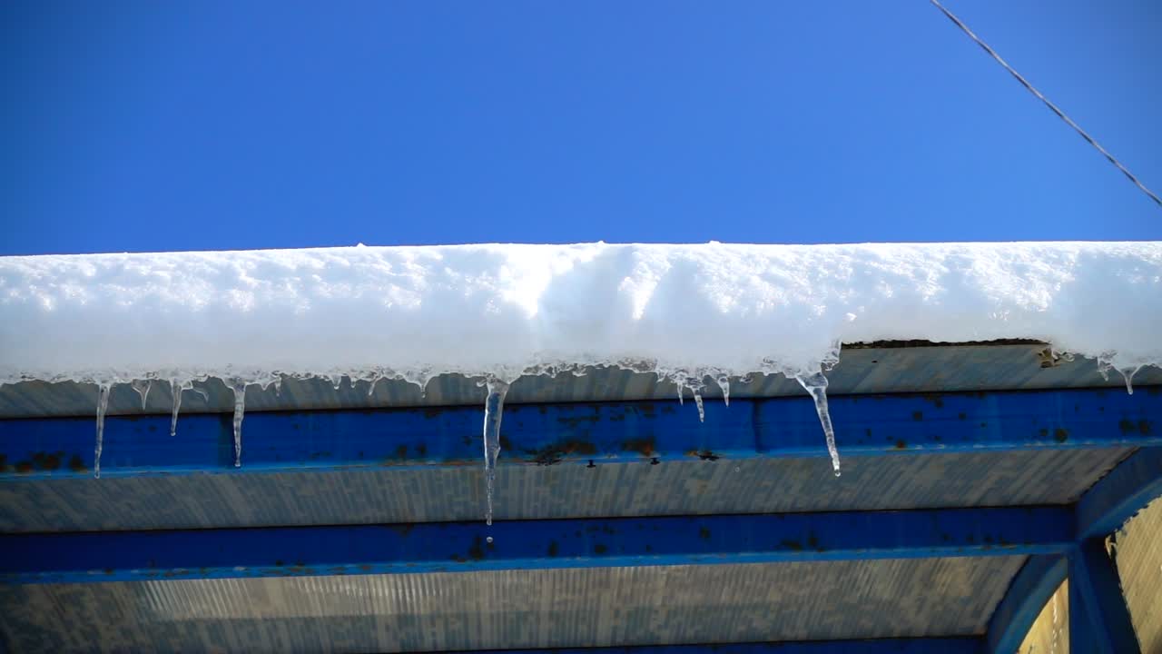 The water dripping from icicles. Shooting in the winter. Slow motion