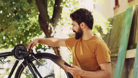 Man-browsing-internet-to-maintain-bike