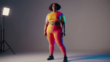 stylish plus-size woman in colorful activewear