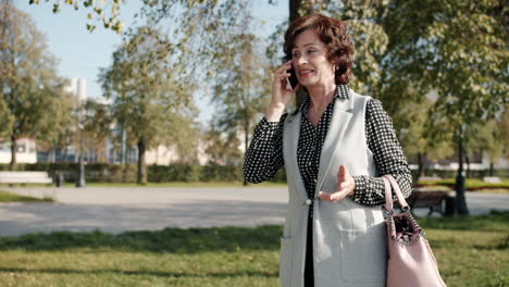 Senior Woman Talking on Phone in Park