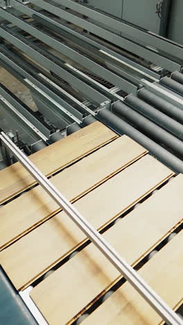 industrial equipment for the production of laminate. several stages of floor production. vertical video