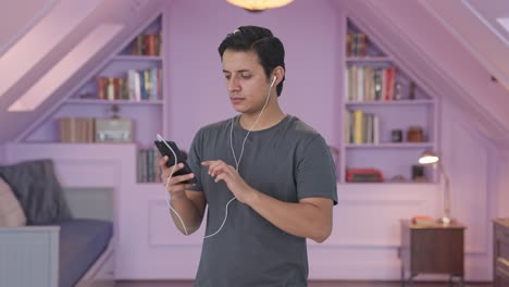 Indian-man-listening-music-on-earphones