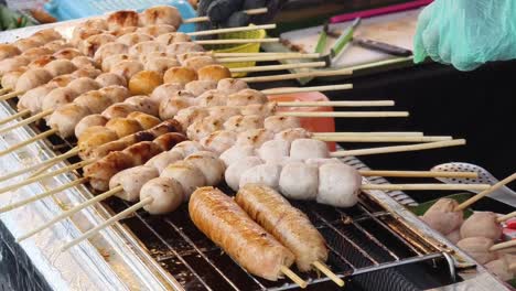 grilled sausage skewers at a thai street market