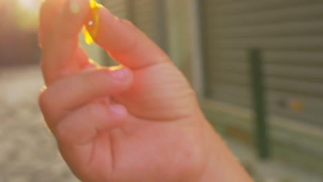 blooming shrub and kid hand with flower petal