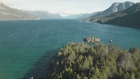 Beautiful-aerial-view-of-a-large-lake-at-the-foot-of-a-mountain-in-Argentina