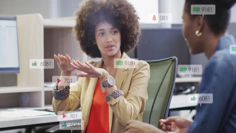 Animation-of-notification-bars-over-diverse-woman-explaining-strategy-to-female-coworker-on-desk