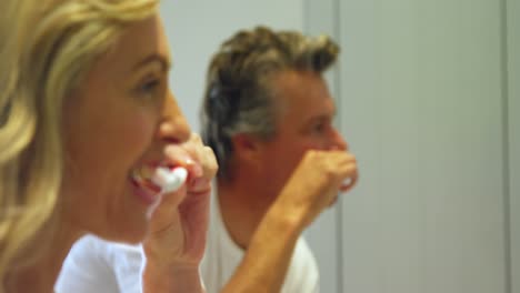 Couple-brushing-teeth-in-bathroom-4k