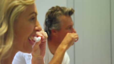 couple brushing teeth in bathroom 4k