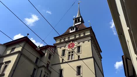 tilt down of historic clock tower in bern city. prison tower of old town during sunny day. capital of switzerland.