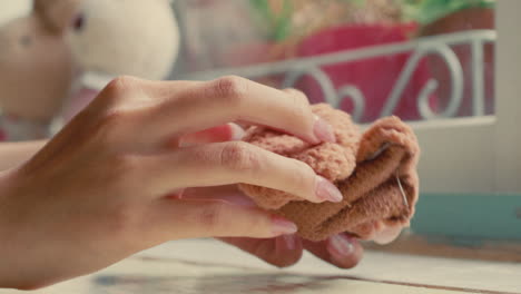 hands holding a piece of brown fabric
