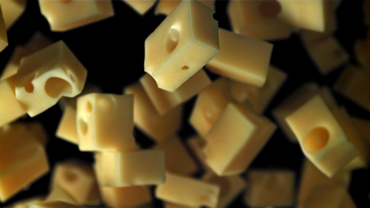 Movimento rallentato di deliziosi cubetti di formaggio svizzero che cadono