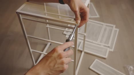 Using-a-Screwdriver-to-Tighten-a-Screw-to-a-Drawer-Unit-Closeup