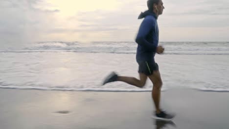 man doing jogging workout at beach