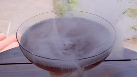 shot of red wine with the smoke into the glass.